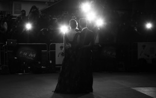 Couple on the red carpet being photographed - black and white