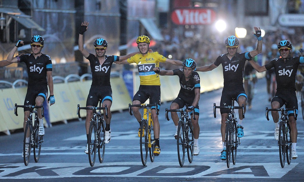 Team Sky cycling team crossing the finish line of the Tour de France in Paris with Chris Froome in Yellow Jersey - sports sponsorship agency