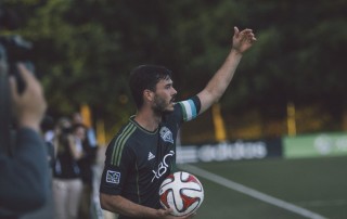 Footballer with ball in hand about to do a throw in