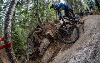 Team CRC Mountain Bike going down a hill in a forest - Sport marketing company