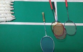 Badminton racquets on a court with shuttlecocks - Gaming Strategy