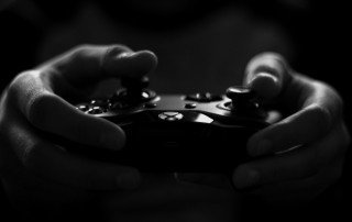 Person holding games controller - black and white