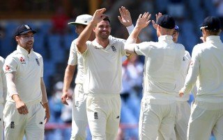 Jimmy Anderson celebrating a cricket wicket with other England players