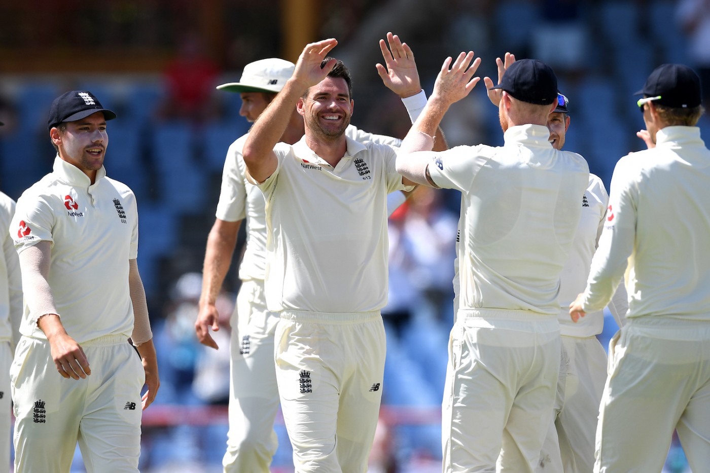 Jimmy Anderson celebrating a cricket wicket with other England players