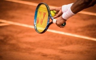 Yonex branding on tennis racket - women's sports sponsorship